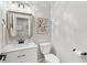 Powder room featuring a white vanity, a sink, a mirror, and a toilet at 5667 Skylark Dr, Greenwood, IN 46143