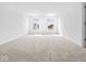 Spacious bedroom featuring plush carpeting, two windows, and neutral walls providing a bright, airy atmosphere at 576 Plowman Dr, Shelbyville, IN 46176