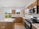 Well-lit kitchen with stainless steel appliances and a center island at 576 Plowman Dr, Shelbyville, IN 46176