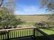 Scenic backyard view from the wooden deck overlooking lush greenery at 636 Mallards Xing # 2-A, Martinsville, IN 46151