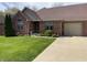 Charming brick home with a well-manicured lawn and attached one car garage at 636 Mallards Xing # 2-A, Martinsville, IN 46151