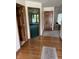 Inviting hallway with hardwood floors and a view into the adjacent rooms at 636 Mallards Xing # 2-A, Martinsville, IN 46151