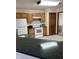 Bright kitchen area with white appliances, wood cabinets, and green countertops at 636 Mallards Xing # 2-A, Martinsville, IN 46151