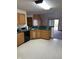 Well-lit kitchen featuring tiled floors, wooden cabinets and black appliances at 636 Mallards Xing # 2-A, Martinsville, IN 46151