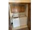 A well-lit laundry room featuring both a washer and dryer and built-in storage at 636 Mallards Xing # 2-A, Martinsville, IN 46151