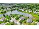 An aerial view showcasing the property nestled within a lush, green neighborhood near a tranquil lake at 6624 Lakestone Ct, Indianapolis, IN 46237