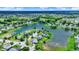 An aerial perspective highlighting a neighborhood near a scenic lake, surrounded by lush greenery at 6624 Lakestone Ct, Indianapolis, IN 46237