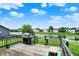 Exterior view of back deck with a grill, overlooking a serene pond and lush green lawn at 6624 Lakestone Ct, Indianapolis, IN 46237