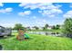 Spacious backyard featuring a climbing play set and pond views, perfect for outdoor enjoyment at 6624 Lakestone Ct, Indianapolis, IN 46237