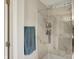 A recently updated walk-in shower with a glass door and stylish white marble-style tile surround at 6624 Lakestone Ct, Indianapolis, IN 46237
