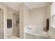 Bright bathroom featuring a large soaking tub and separate walk in shower at 6624 Lakestone Ct, Indianapolis, IN 46237