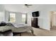 Comfortable bedroom with a ceiling fan, large windows, soft carpet, and plenty of light at 6624 Lakestone Ct, Indianapolis, IN 46237