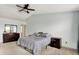 Cozy bedroom with soft carpeting, ceiling fan, dresser, nightstand, and serene decor at 6624 Lakestone Ct, Indianapolis, IN 46237