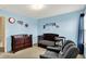 A lovely Bedroom with a wood crib and dresser with comfortable gray recliner at 6624 Lakestone Ct, Indianapolis, IN 46237