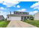 Attractive two-story home boasts white-painted brick, an attached two-car garage, and a green lawn at 6624 Lakestone Ct, Indianapolis, IN 46237
