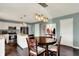 Cozy eat-in kitchen area with pendant lighting and a transition to the entry with coat rack at 6624 Lakestone Ct, Indianapolis, IN 46237