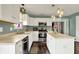 Bright kitchen features white cabinets, stainless steel appliances, and dark hardwood flooring at 6624 Lakestone Ct, Indianapolis, IN 46237