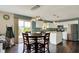 Open-concept kitchen flows into the dining area with stainless steel appliances and abundant natural light at 6624 Lakestone Ct, Indianapolis, IN 46237