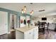 Open kitchen view with a kitchen island and coat rack, seamless transition to the hallway and dining area at 6624 Lakestone Ct, Indianapolis, IN 46237