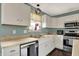 Well-lit kitchen featuring stainless steel appliances, white cabinetry, and modern fixtures at 6624 Lakestone Ct, Indianapolis, IN 46237