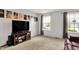 Comfortable living room featuring a flat-screen TV, media storage, and large windows for natural light at 6624 Lakestone Ct, Indianapolis, IN 46237