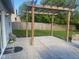 Back patio with decorative wooden pergola, with mature landscaping and a stained privacy fence at 6625 Wolverine Way, Indianapolis, IN 46237