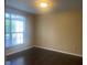A cozy bedroom with a window that lets in natural light with hardwood floors at 6625 Wolverine Way, Indianapolis, IN 46237