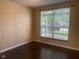 Bright bedroom featuring hard wood floors, neutral paint, and a street view at 6625 Wolverine Way, Indianapolis, IN 46237