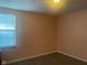 Cozy bedroom features a large window, providing natural light and an airy feel with modern flooring at 6625 Wolverine Way, Indianapolis, IN 46237