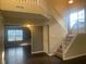 Bright foyer with hardwood floors, staircase, and an open view to living spaces at 6625 Wolverine Way, Indianapolis, IN 46237