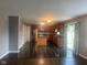 Open concept kitchen with central island, stainless steel appliances, and hardwood floors at 6625 Wolverine Way, Indianapolis, IN 46237