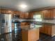 A full view of a kitchen complete with island, stainless steel appliances, and a tile floor at 6625 Wolverine Way, Indianapolis, IN 46237