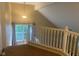 Landing area featuring a bright window with curtains and a decorative railing at 6625 Wolverine Way, Indianapolis, IN 46237