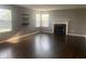 Spacious living room with hardwood floors, fireplace, and large windows at 6625 Wolverine Way, Indianapolis, IN 46237
