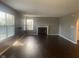 Inviting living room featuring hardwood floors, fireplace, and ample natural light at 6625 Wolverine Way, Indianapolis, IN 46237