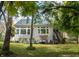 Spacious backyard with lush lawn, mature trees, and comfortable patio seating at 665 Featherstone Dr, Westfield, IN 46074