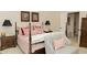 Bedroom with a four-poster bed with red patterned linens, a sitting chair, and two bedside tables at 665 Featherstone Dr, Westfield, IN 46074