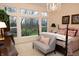 Bright bedroom featuring large windows, a sitting area, and a four-poster bed with patterned linens at 665 Featherstone Dr, Westfield, IN 46074
