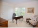 Bright bedroom featuring a stylish desk, chair, and a serene view from the large window at 665 Featherstone Dr, Westfield, IN 46074