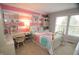Bedroom featuring a striped accent wall, desk, and a bed with colorful patterned bedding at 665 Featherstone Dr, Westfield, IN 46074
