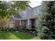 A lovely two-story house with a brick and stone exterior, a charming porch, and a meticulously landscaped front yard at 665 Featherstone Dr, Westfield, IN 46074