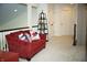 Bright upstairs landing featuring a cozy red couch and decorative shelving at 665 Featherstone Dr, Westfield, IN 46074