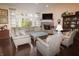Cozy living room featuring a fireplace, large windows, hardwood floors, and comfortable seating at 665 Featherstone Dr, Westfield, IN 46074