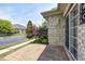 Back patio with a brick-paved surface, a partial view of the lawn and shrubbery, and the house with a sliding door at 6816 Park Square Dr # C, Avon, IN 46123