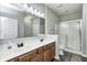 A bathroom featuring a double sink vanity with dark wood cabinets and a glass door shower at 6816 Park Square Dr # C, Avon, IN 46123