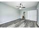 Spacious bedroom with wood-look floors, a ceiling fan, walk-in closet, and an ensuite bathroom at 6816 Park Square Dr # C, Avon, IN 46123