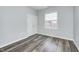 A well-lit bedroom featuring gray walls, wood-look floors, closet and a window at 6816 Park Square Dr # C, Avon, IN 46123