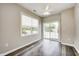 Bright bedroom featuring wood-look floors, a ceiling fan, a window with blinds and sliding door access to the yard at 6816 Park Square Dr # C, Avon, IN 46123