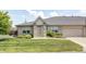 Well-maintained home featuring a brick facade, an attached garage, green lawn, and manicured landscaping at 6816 Park Square Dr # C, Avon, IN 46123