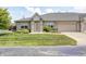 Home boasts a brick facade, attached garage, mature trees, landscaped beds, and a lush green lawn at 6816 Park Square Dr # C, Avon, IN 46123